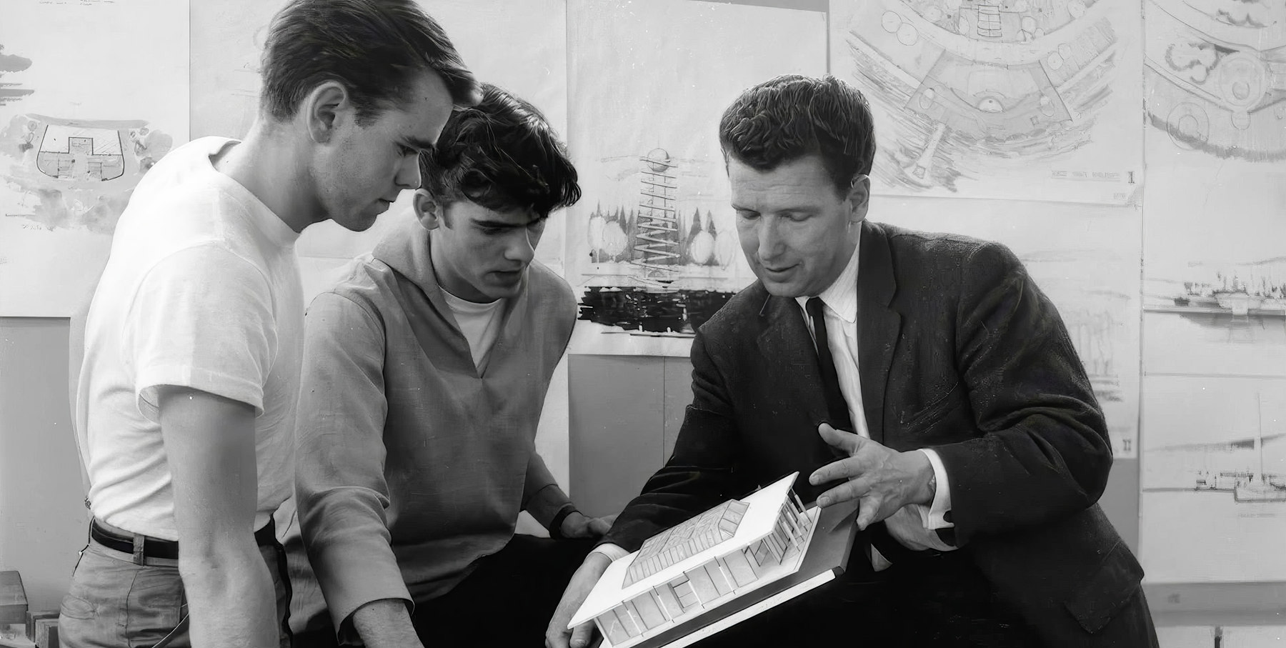 Arthur Erickson examining an architectural model with colleagues