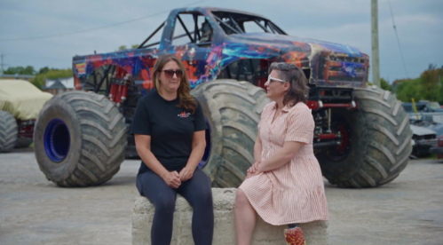 Christa Couture and a guest beside a monster truck