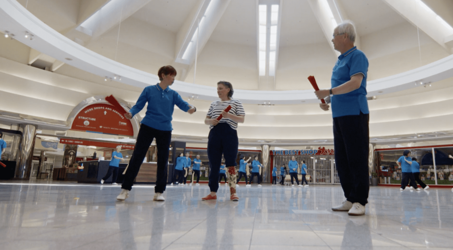 Christa Couture joining a group activity in a bright circular hall