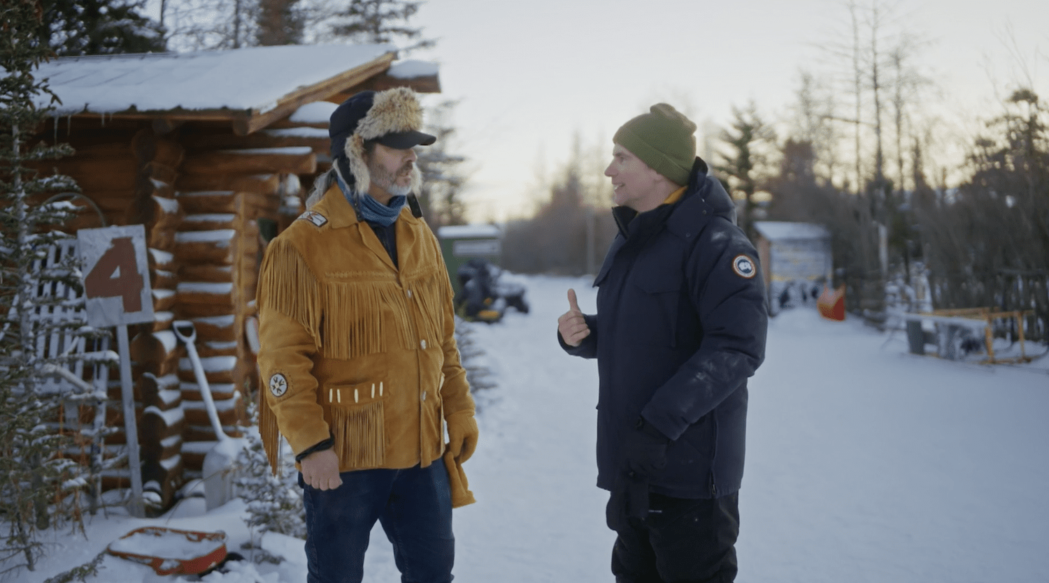 Christa Couture talking with a local outdoors in winter
