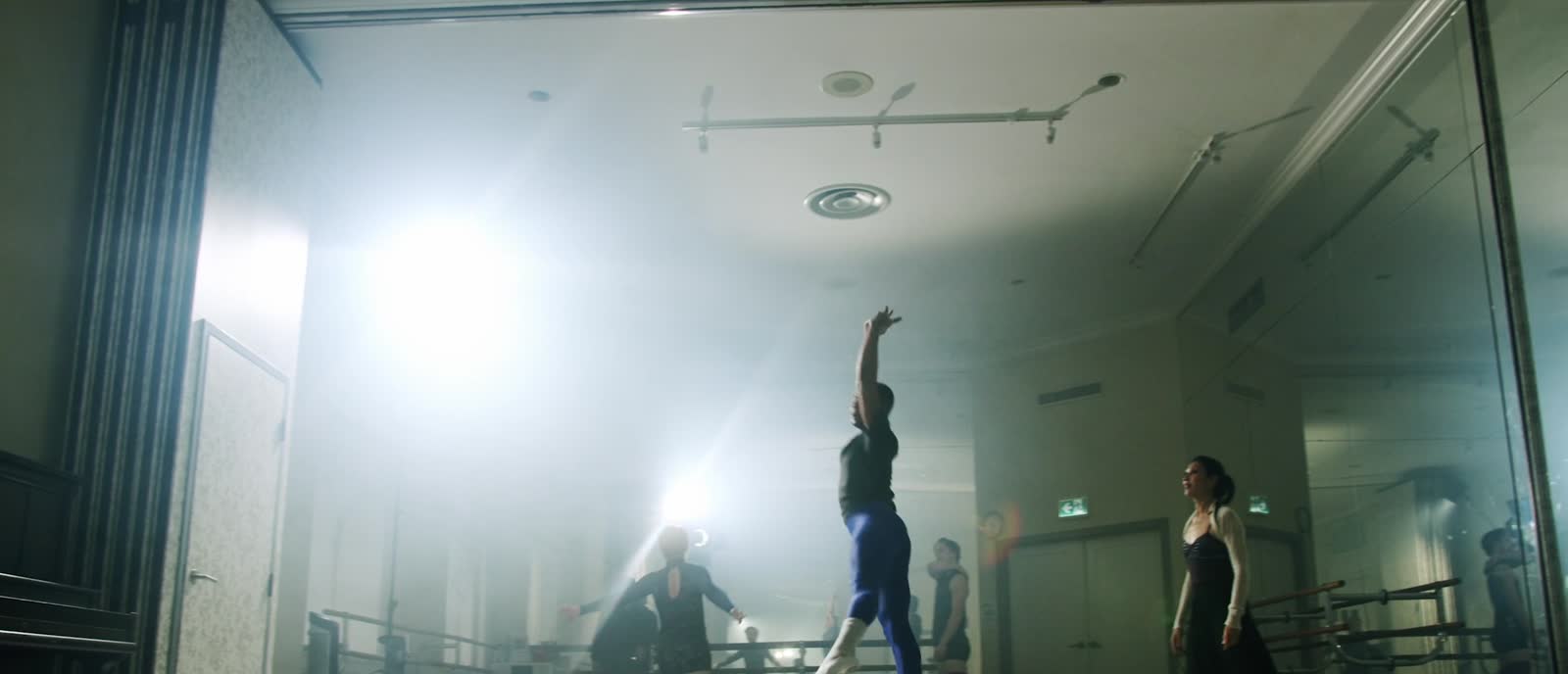 A ballet dancer rehearsing in a light-filled studio