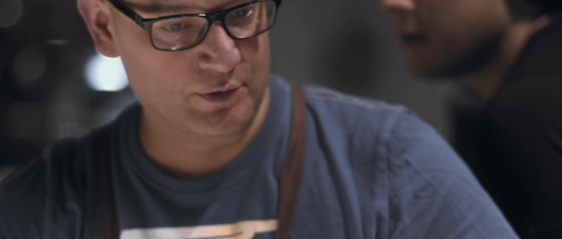 A chef in glasses sharing a meal