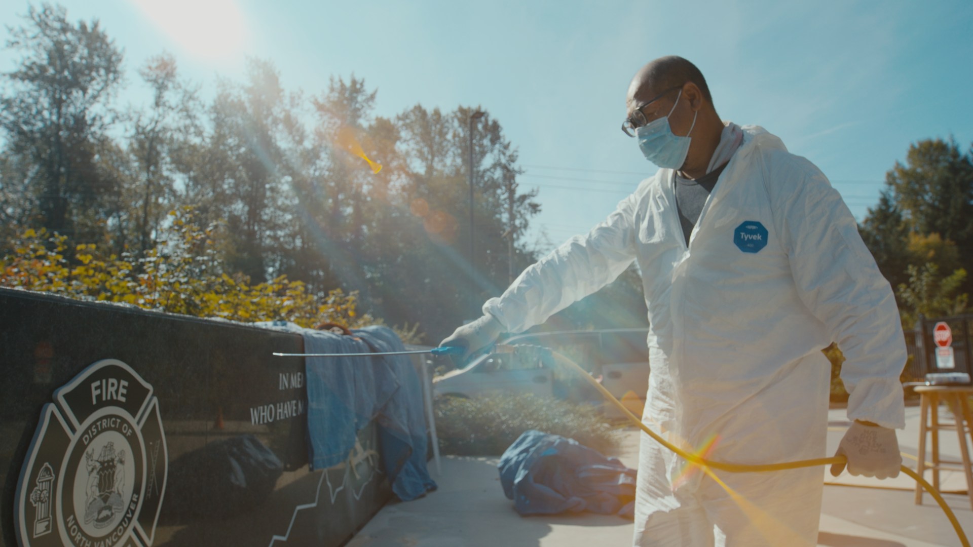 A person working on an outdoor memorial in sunlight