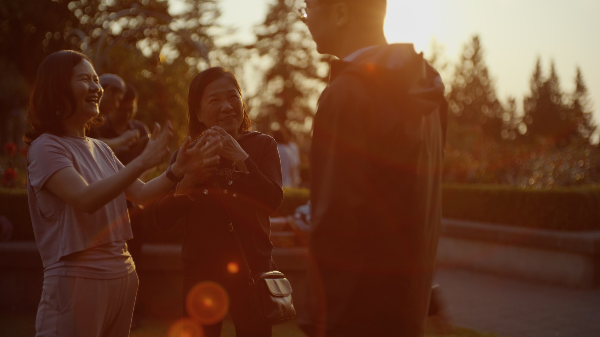 People talking together outdoors in warm evening light